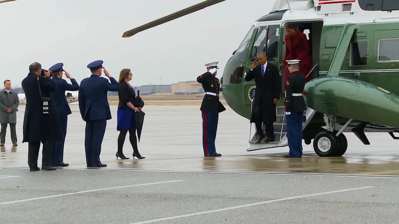 President Barack Obama And Michelle Obama Exit A Helicopter And Are Warmly Greeted By Members Of The Military