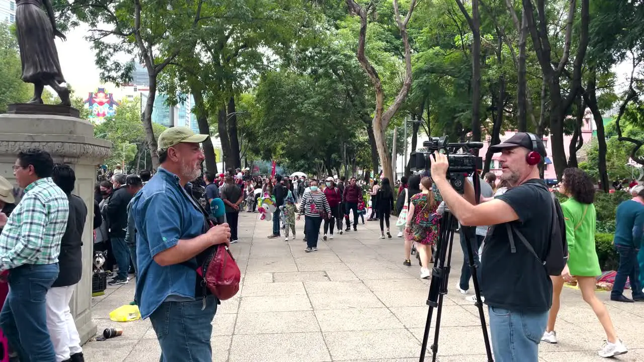 parade shot of a reporter being interviewed during the mexico city military parade