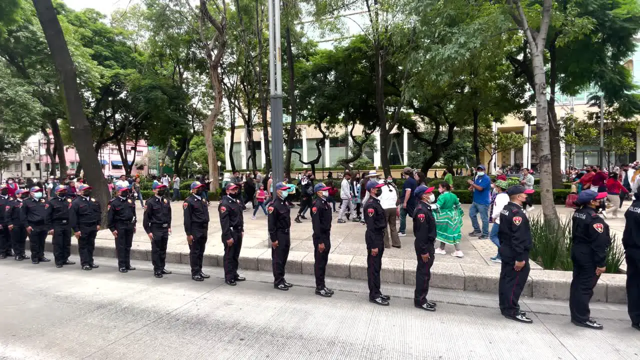 shot of a line of police officers passing assistance during the military parade in mexico city