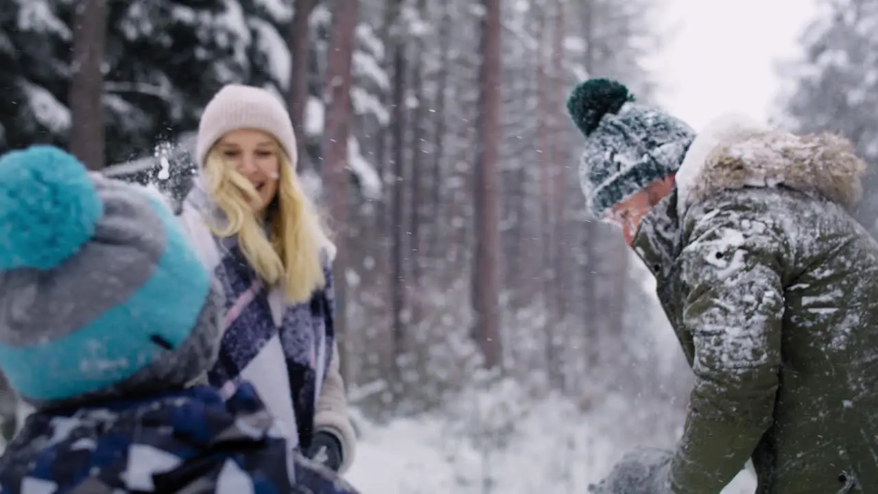 Video of family having a snowball fight in the snow