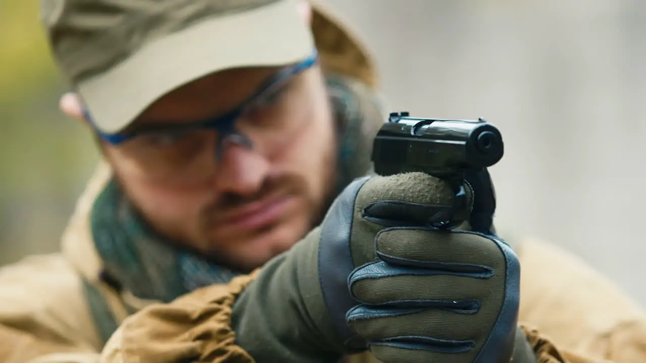 A man plays airsoft with a pistol in his hand 4