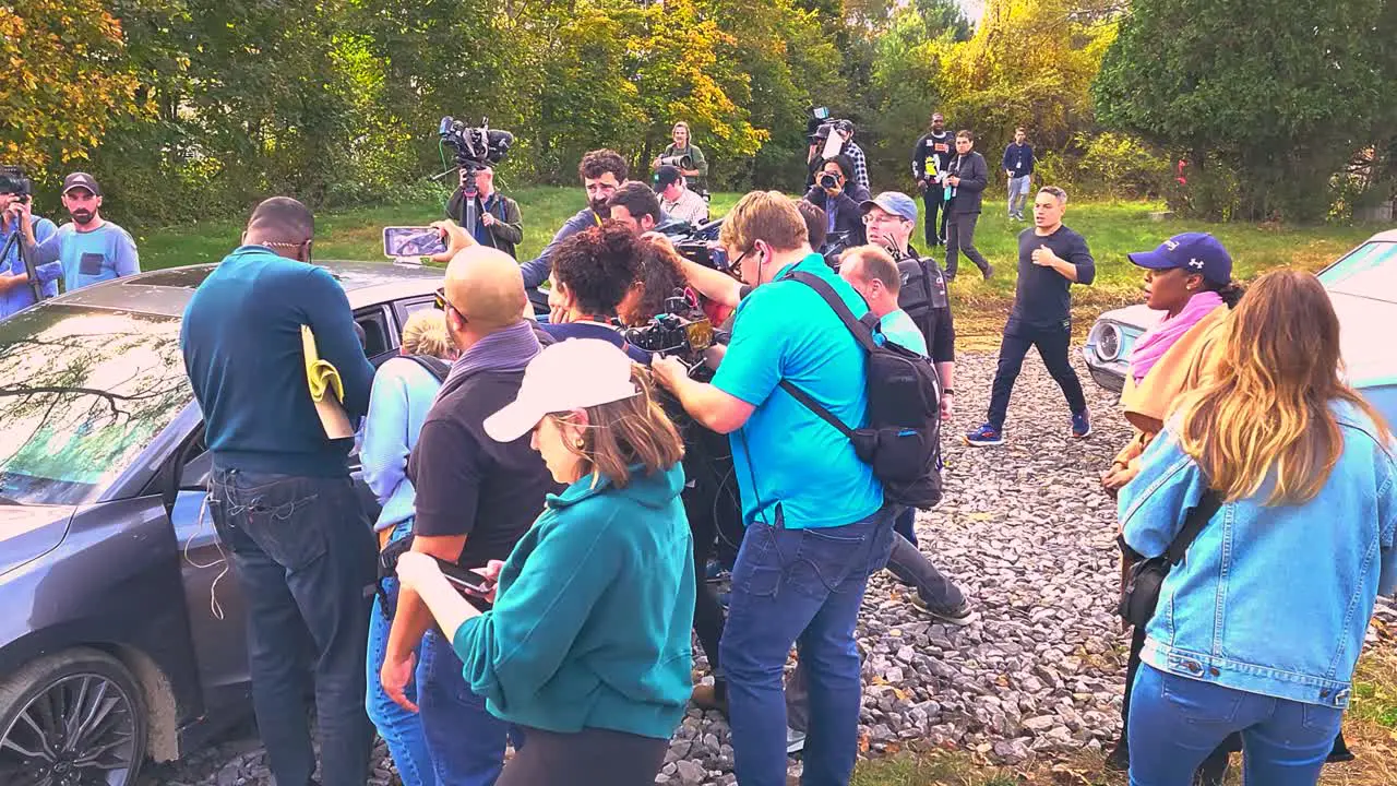 News media personnel filming around car during Lewiston Maine mass shooting manhunt