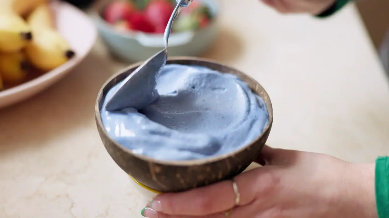 Smoothie bowl and hand of woman prepare breakfast