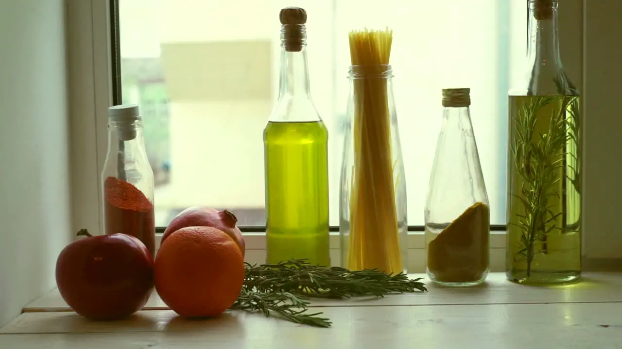 Food ingredients near kitchen window Cooking oil and kitchen herbs