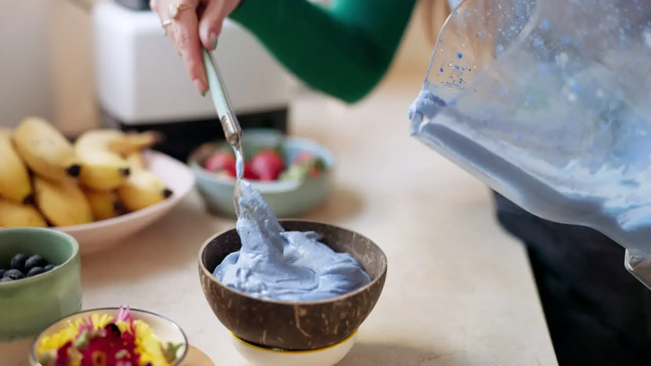 Woman hand and prepare smoothie bowl in kitchen