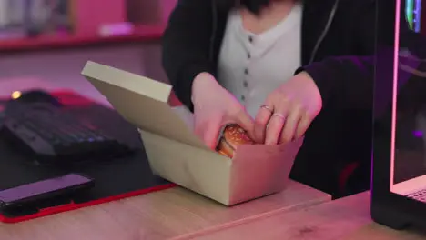 Gaming fast food and asian woman eating burger