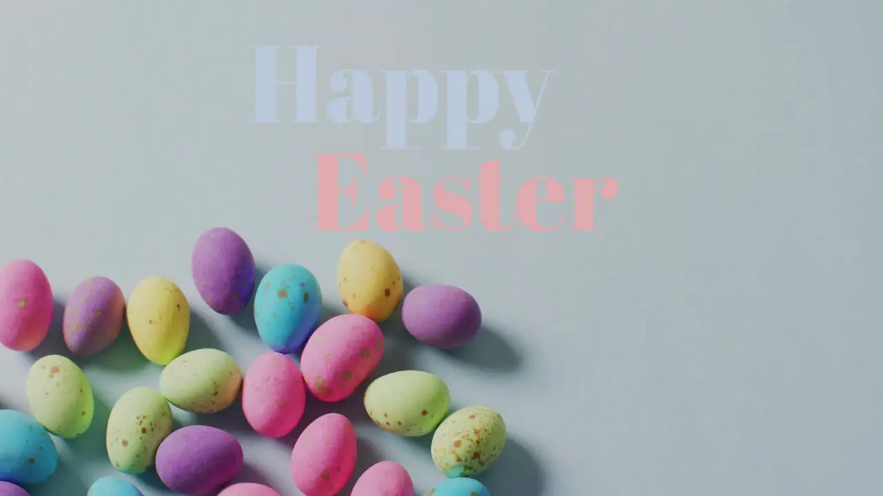 Animation of happy easter text over colourful easter eggs on grey background