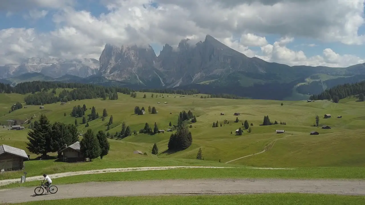 One guy cycles through the Mountains Ranges of the Seiser Alm Italian Alps Urtisei Urtijei Alpe di Siusi Italy Europe