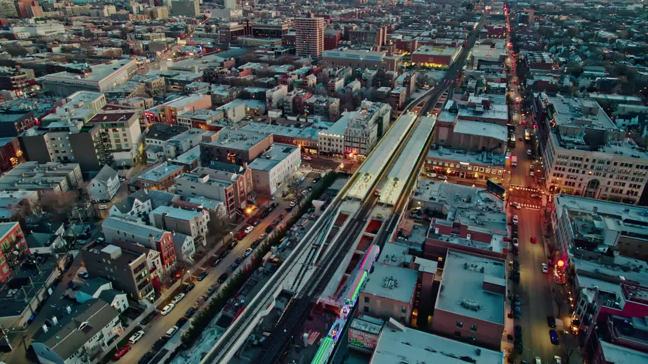 revealing cta holiday train decorated in chistmas on Brown Lane railroad and tilting up with an epic chicago skyline view at sunset 4k