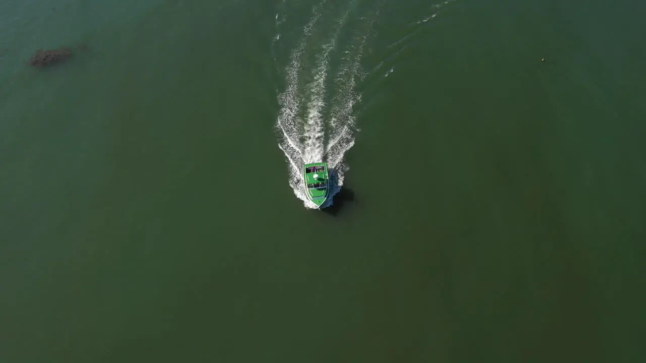 Aerial High Pan Follow and Reveal Drone Footage of green Lobster Boat approaching Maine Coast Vinalhaven Fox Islands Knox County Maine USA