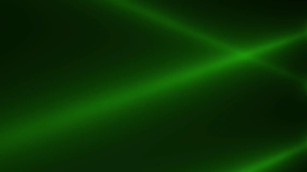 Glowing green spotlight beams on stage