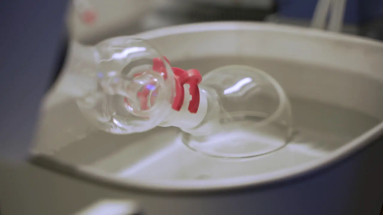 Glass beaker spinning in water in science lab