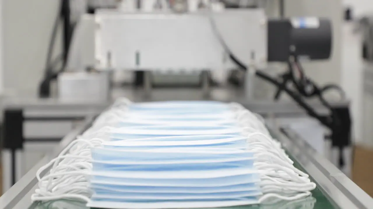 3 Ply Disposable Surgical Mask Coming Out From Machine Into Delivery Mechanism Conveyor