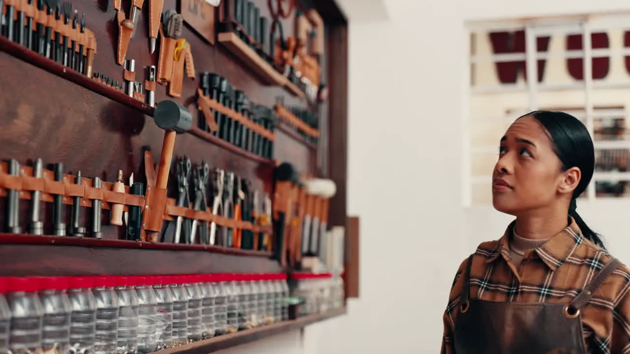 Leather tools and designer with woman in workshop