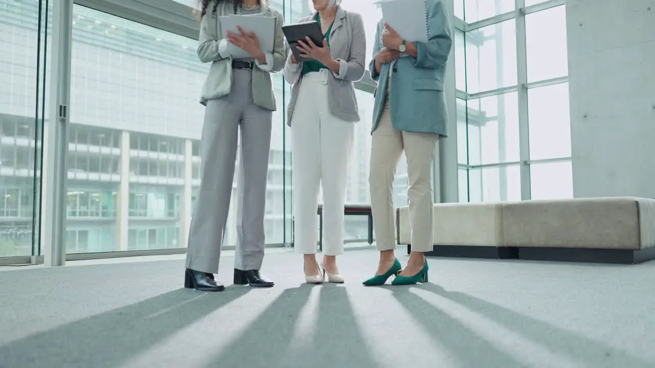 Legs tablet and business people in an office