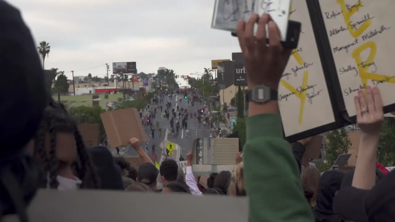 Hundreds of protesters hold signs and chant during a black lives matter protest in Downtown San Diego