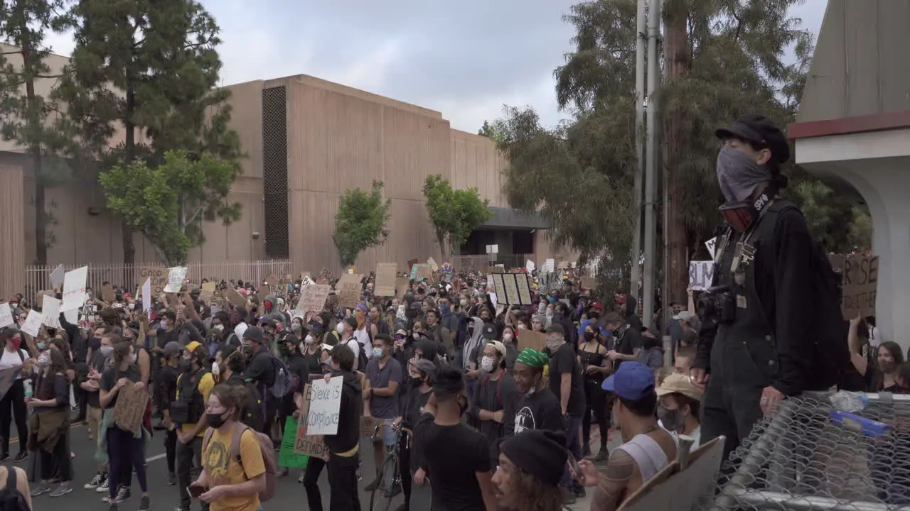 Cinematic zoom out shot of crowd of protesters gathered in Downtown San Diego after the police killing of George Floyd