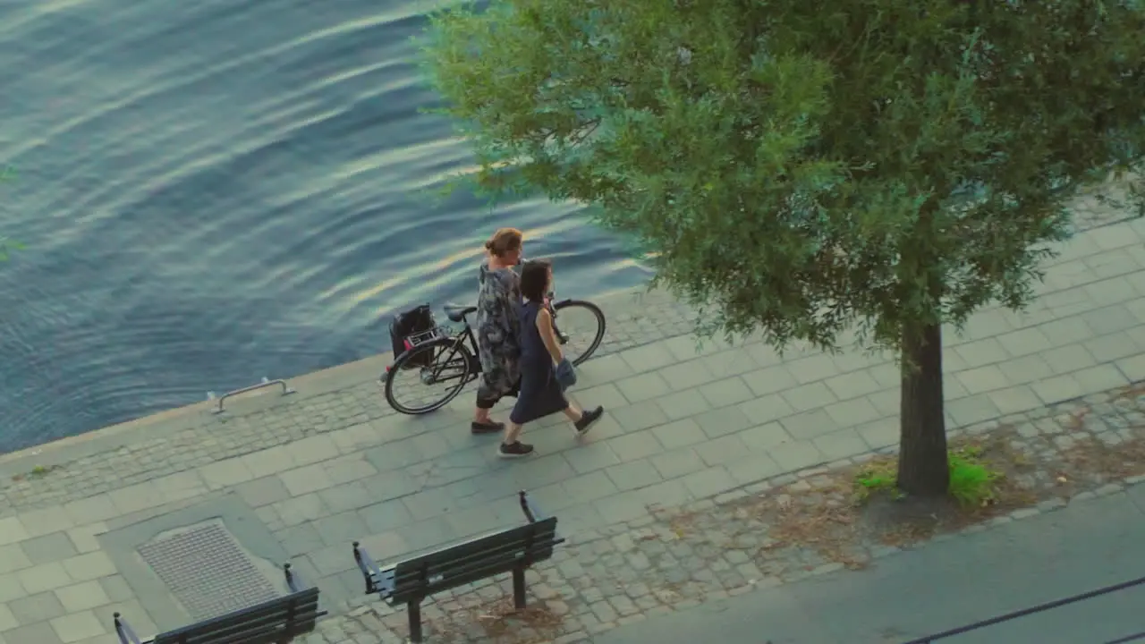 Two women walk along the banks of Stockholm's old town