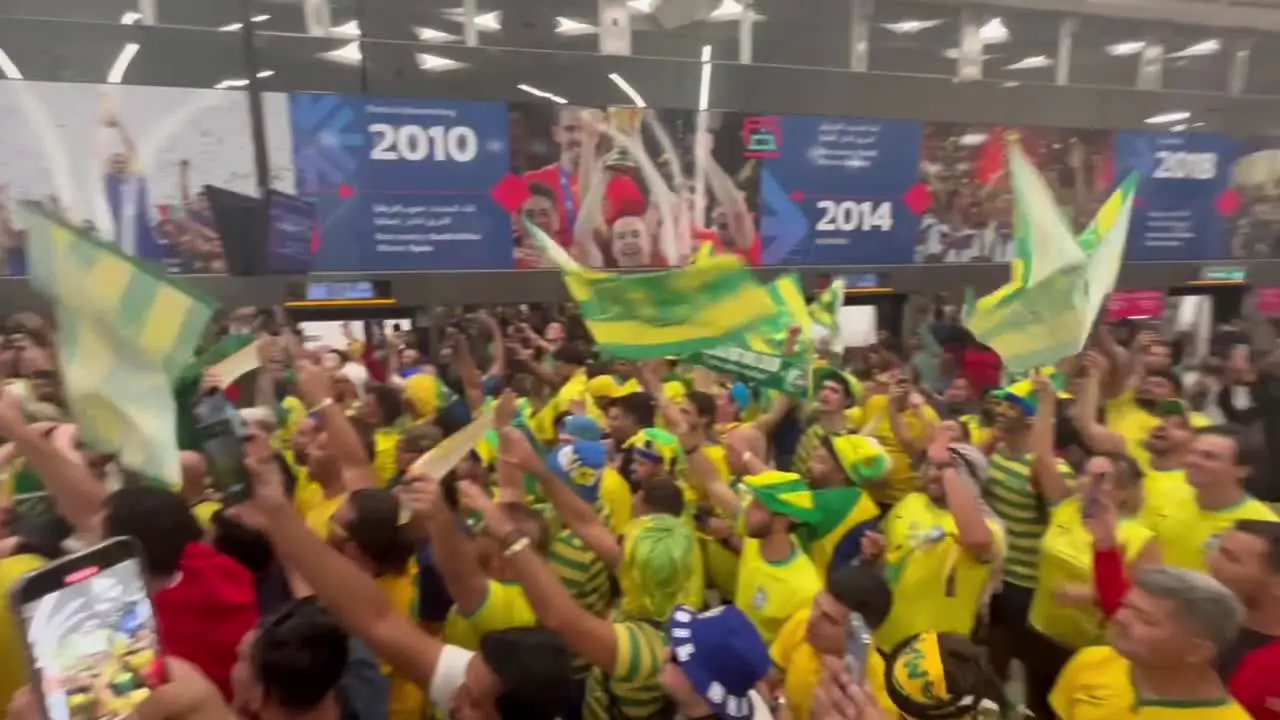 Brazilian fans celebrating on subway platform in Doha