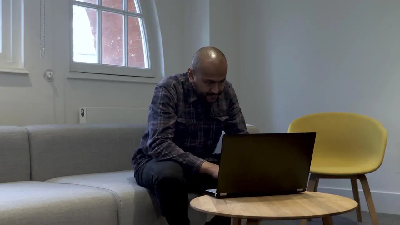 Middle Aged Asian Family Man Working from Home on Laptop