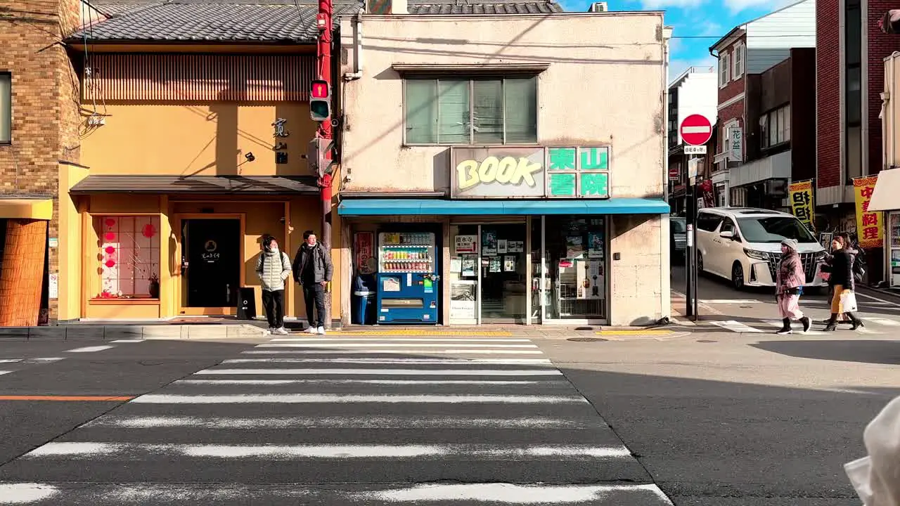 Two Young Asian Male Waiting at Zebra Crossing Kyoto Japan