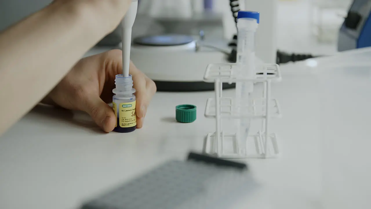 Slow motion close up orbiting shot of lab work with test tubes