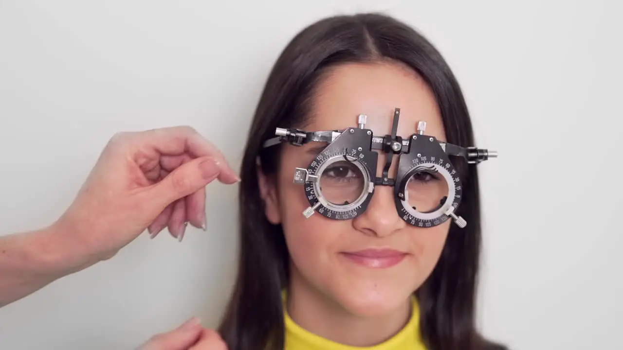 little girl trying on lens at optometrist