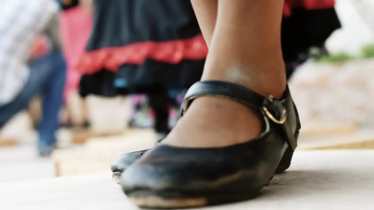 Native person doing tap dance in wood box