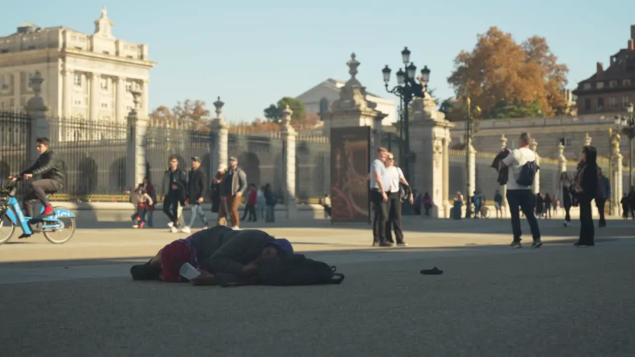 Homeless person sleeps in front of the royal palace