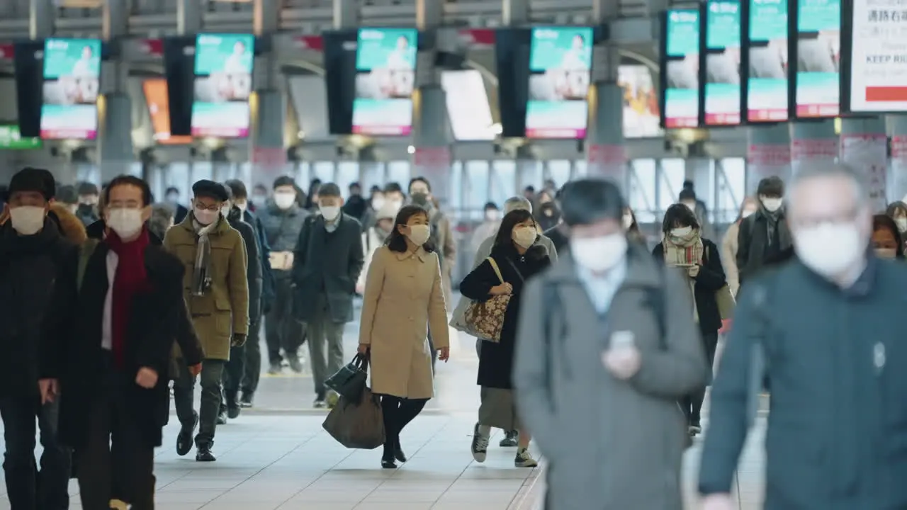 Tokyo Japan Slow Motion Of People Wearing Hygiene Facemasks Walking Inside Shinagawa Station During Pandemic Medium Shot