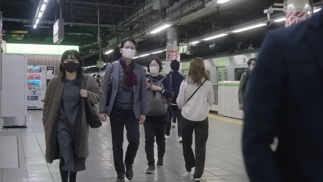 Japanese Commuters Wearing Mask Walking On Platform Of Subway Station During Corona Virus Pandemic In Tokyo Japan