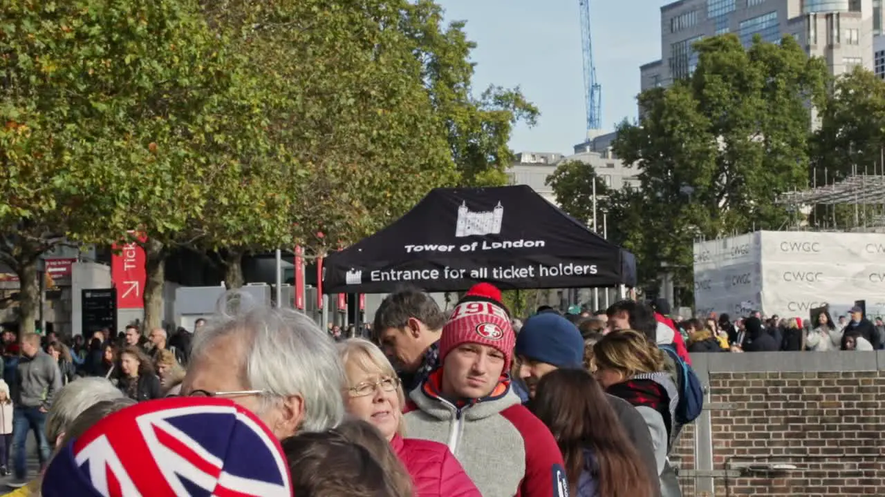 In front of the crowd of people waiting to buy a ticket to enter the Tower of London England