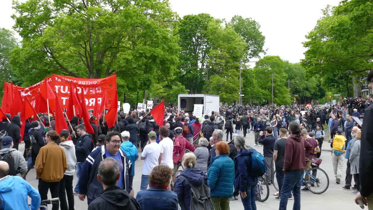 Anti-G7 Protesters With Red Flags Marching Calmly Down the Street Québec City Canada