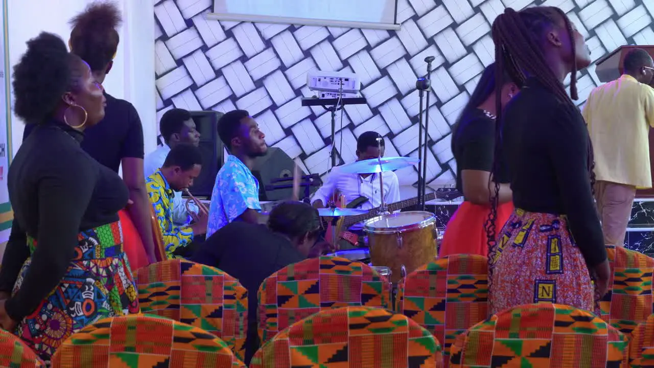 African people in rustic church orchestra playing instruments and singing