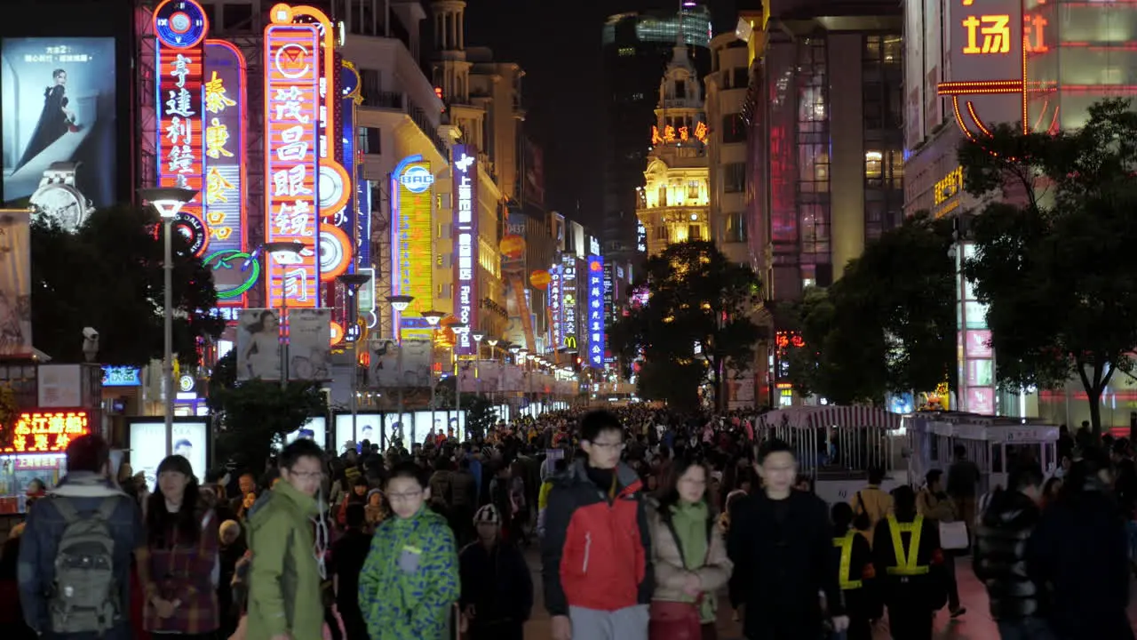 Crowded with people neon bright Nanjing Road at night time Shanghai 4K