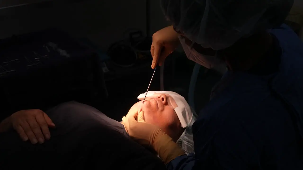 obesity jowl liposuction surgery in operating room doctor operating face aesthetic surgery