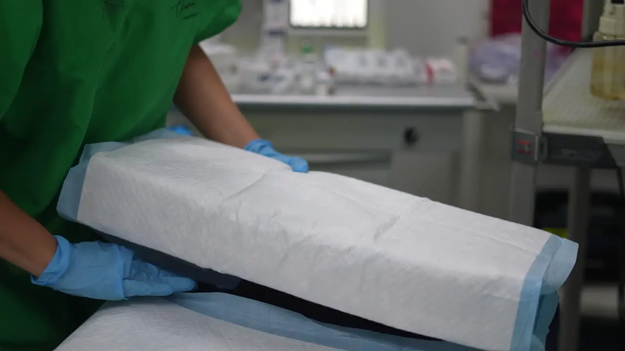 nurse placing pillow on hospital bed in operating room surgery room