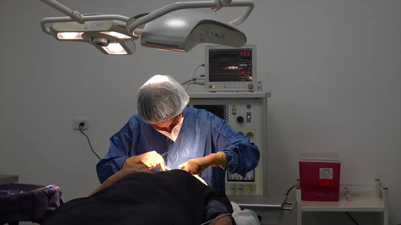 doctor performing surgery in the operating room