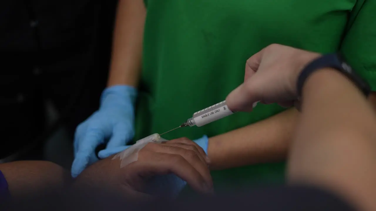 placement of anesthesia on the patient's hand operating room hospital clinic injection