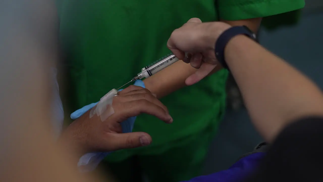 placement of anesthesia on the patient's hand operating room hospital