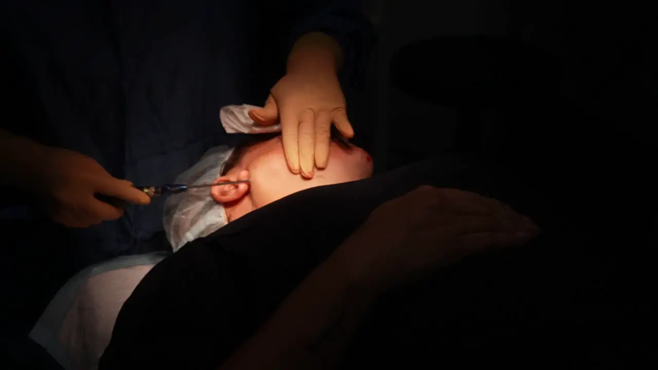 jowl liposuction surgery in operating room doctor operating on face clinic cosmetic surgery