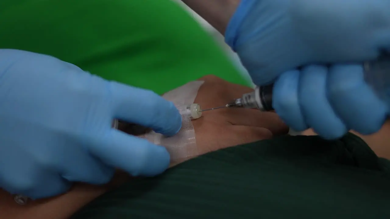 physician placing anesthesia in patient's hand injection