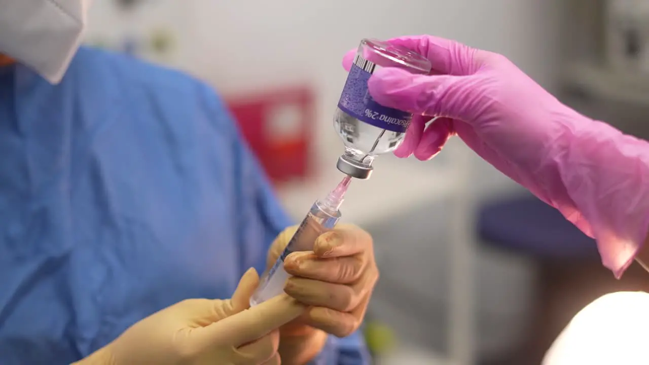 doctors with syringe and anesthesia in operating room medical operation anesthetic injection hospital