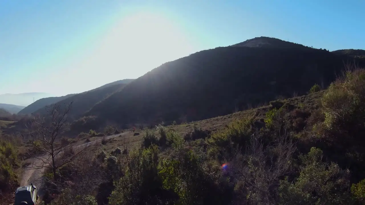 Off road car driving fast on gravel under hill track