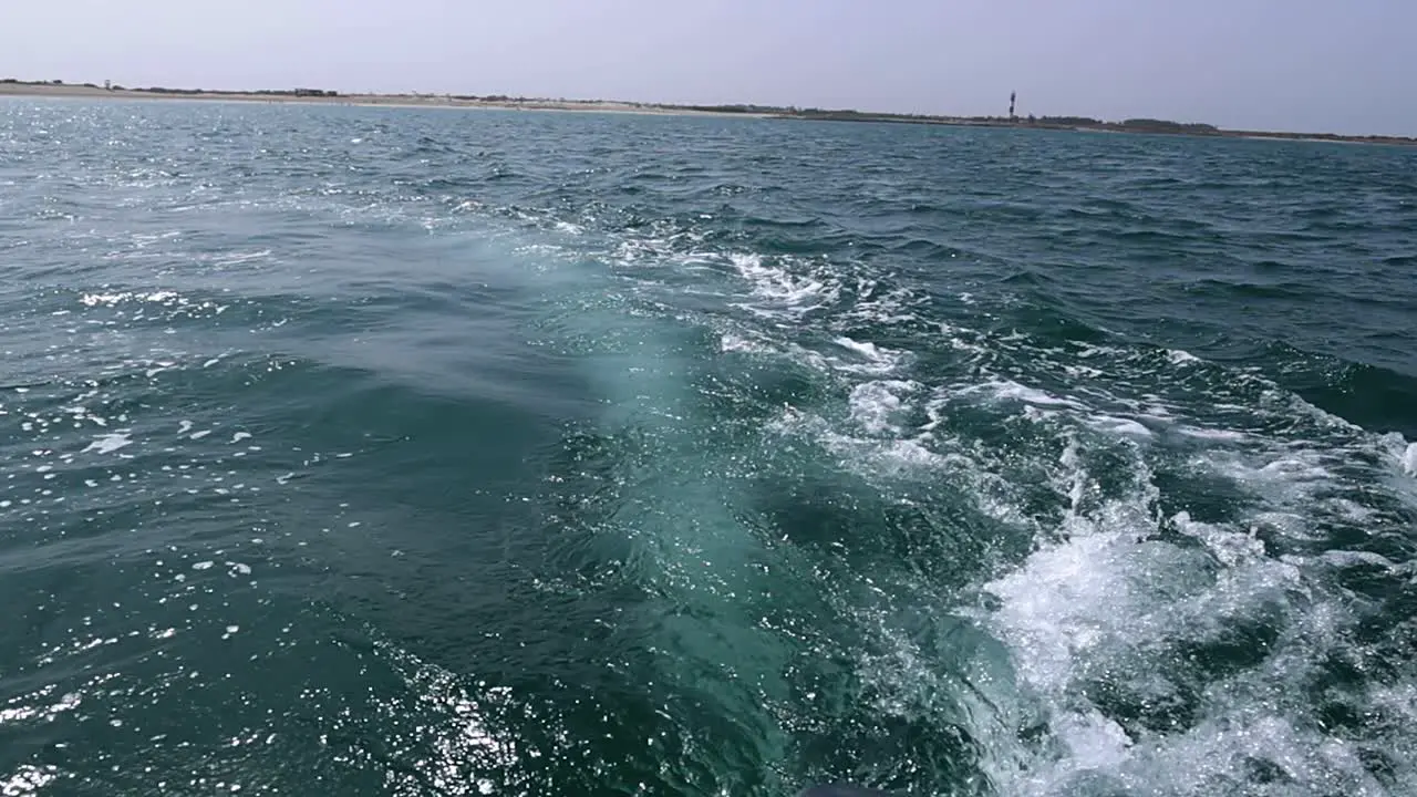 Background water surface behind of fast moving motor boat