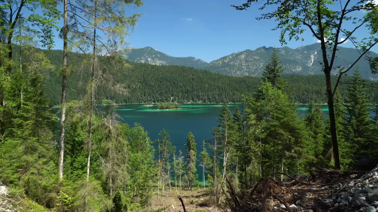 Beautiful Eibsee lake in Bavaria with small islands turquoise water and forest around