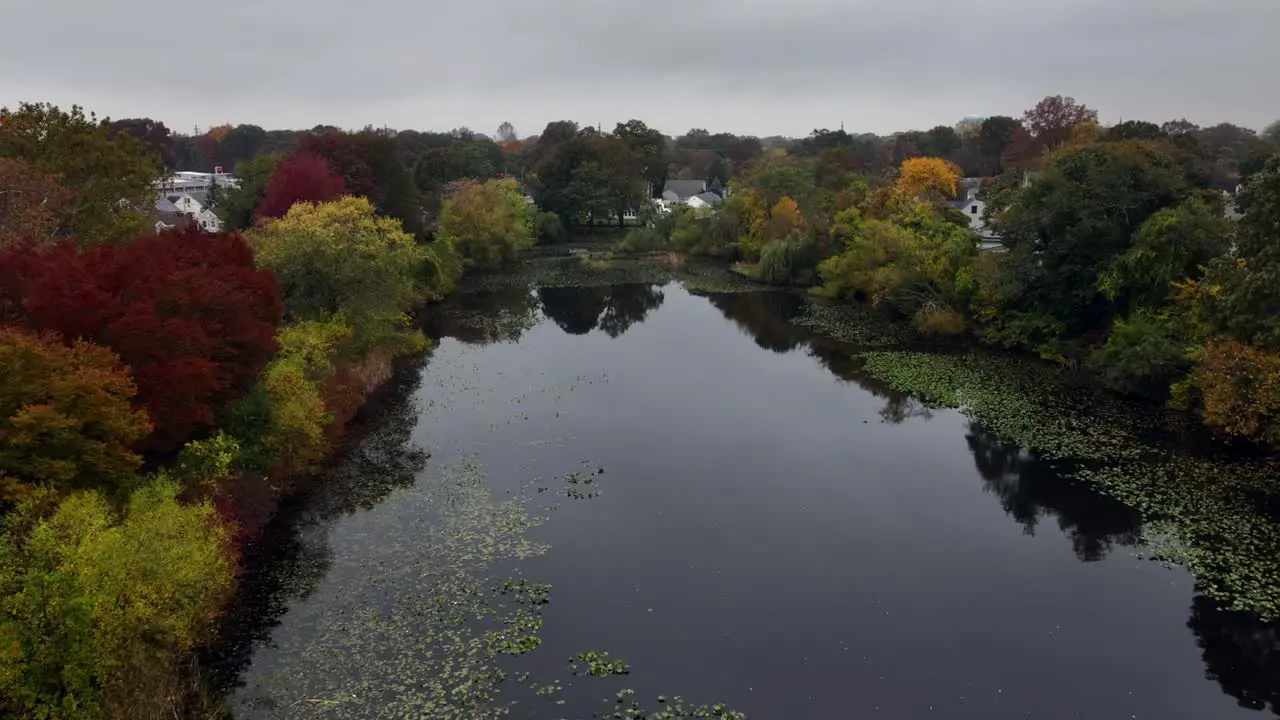 An aerial view over a peaceful pond on Long Island New York on a cloudy day in autumn