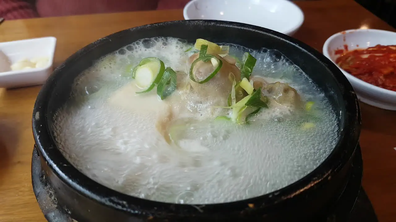 Ginseng chicken or samgyetang served boiling on a hotpot