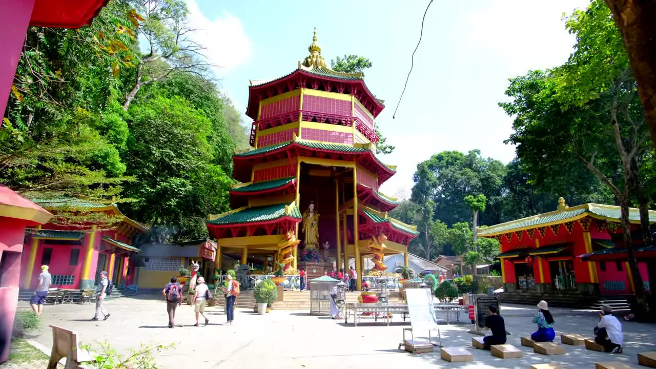 Thai Temple with people praying and tourists seeing