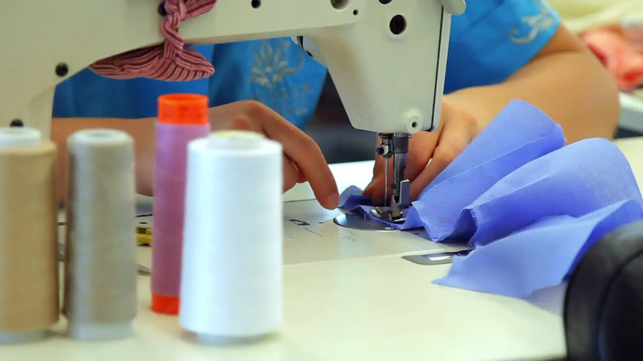 Female hand working on industrial sewing machine Textile industry concept